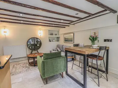 a living room with a table and a couch at Wisteria in Ambleside