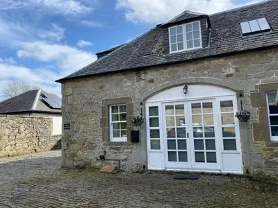 an old stone building with a white door at House - Sleeps 4 Pet Friendly & Free Parking in Symington