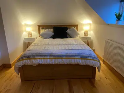 a bedroom with a large bed with two night lights at House - Sleeps 4 Pet Friendly & Free Parking in Symington