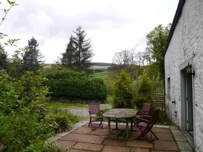 a table and chairs sitting on a patio at Old Coach House in Moniaive
