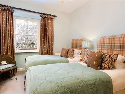 a bedroom with two beds and a window at Stone Beck in Ambleside