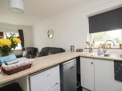 a kitchen with a counter top and a sink at Shoreside Cottage in Wigton