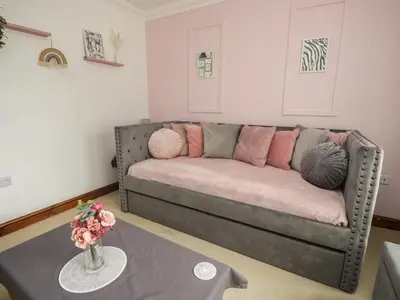 a living room with a couch and a table at Shoreside Cottage in Wigton