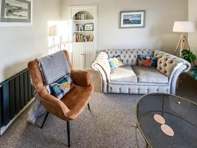 a living room with a couch and a glass table at 9A Church Place in Kirkcudbright