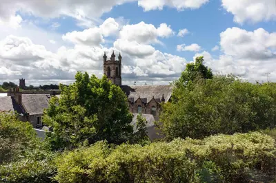 an old building with a clock tower in the background at Walker Suite No 60 - Donnini Apartments in Kilmarnock