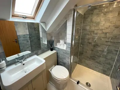 a bathroom with a shower and a toilet and a sink at Beautifully Presented 3BR Luxury Apartment - Pass the Keys in Kirkcudbright