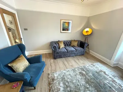 a living room with a couch and a chair at Beautifully Presented 3BR Luxury Apartment - Pass the Keys in Kirkcudbright