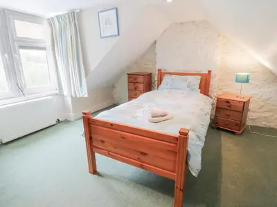 a bedroom with a bed with a wooden bed frame at Strathannan in Moffat