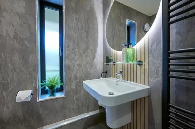 a bathroom with a white sink and a window at Riverside Park 6 in Keswick