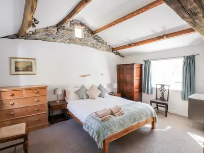 a bedroom with a large bed and a window at One Town End in Penrith