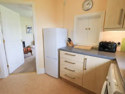 a kitchen with a white refrigerator and a counter at Limhus Cottage in Keswick