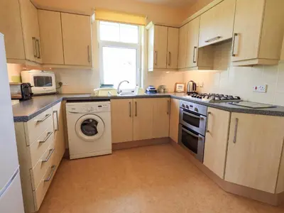 a kitchen with a sink and a dishwasher at Limhus Cottage in Keswick