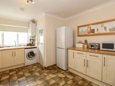 a kitchen with a refrigerator and a washer and dryer at Inglewood in Keswick