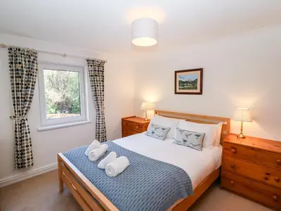 a bedroom with a bed with two towels on it at Annes Cottage in Keswick