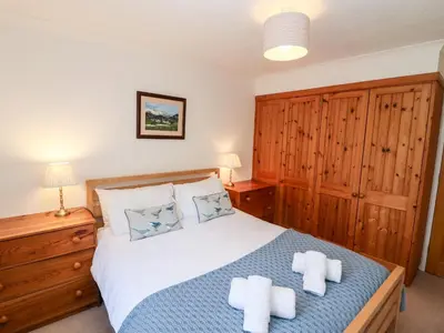 a bedroom with a bed with two towels on it at Annes Cottage in Keswick