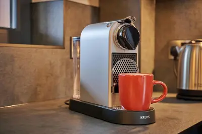 a toaster sitting on a counter with a red cup at Riverside Park 5 in Keswick