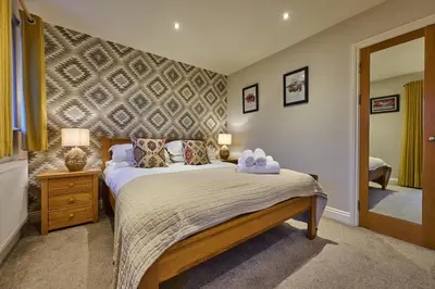 a bedroom with a bed with two towels on it at Riverside Park 5 in Keswick