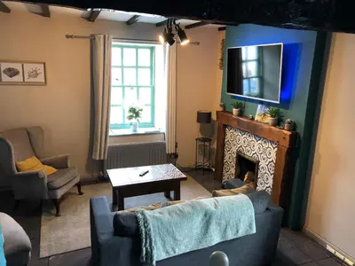a living room with a couch and a fireplace at 2 Fleet Street in Castle Douglas