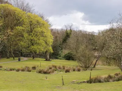 a park with green grass and trees in the background at 2 Fleet Street in Castle Douglas