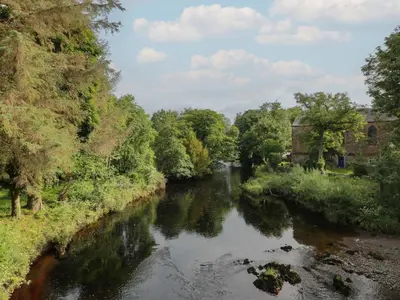 a river with trees on the side of it at 2 Fleet Street in Castle Douglas