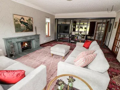 a living room with two white couches and a fireplace at Dale View in Cockermouth