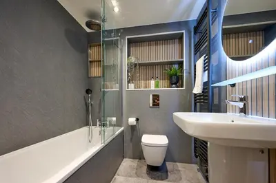 a bathroom with a white toilet and a sink at Riverside Park 3 in Keswick