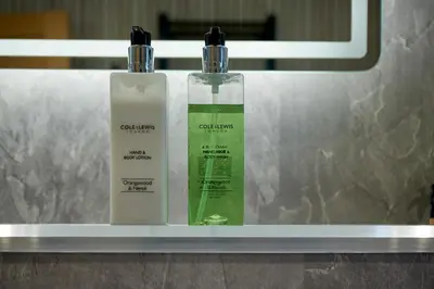 two bottles of soap on a shelf in a bathroom at Riverside Park 2 in Keswick