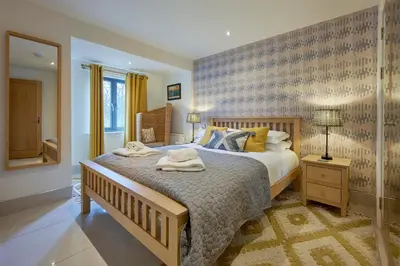 a bedroom with a large bed with towels on it at Riverside Park 2 in Keswick