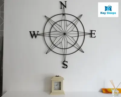 a large metal compass wall art on a white wall at NEW Four Bedroom House By Keysleeps Short Lets Workington Contractor Leisure Beach Location Lake District in Siddick