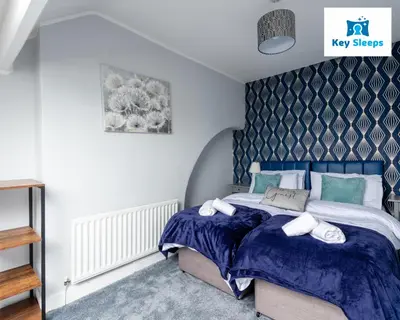 a bedroom with a bed with blue and white sheets at NEW Four Bedroom House By Keysleeps Short Lets Workington Contractor Leisure Beach Location Lake District in Siddick
