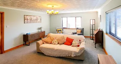 a living room with a couch and a table at Gretna Getaway in Gretna