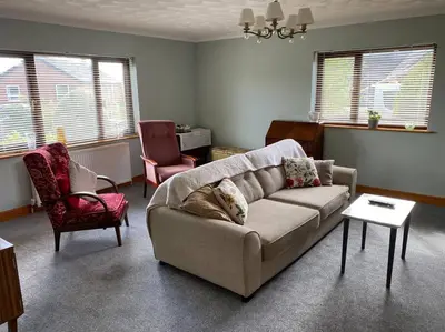 a living room with a couch and two chairs at Gretna Getaway in Gretna