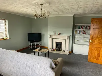 a living room with a couch and a fireplace at Gretna Getaway in Gretna