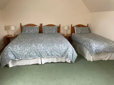a bedroom with two beds and two lamps at Corehouse Farm Cottages - Dairy, Granary & Sawmill in Lanark