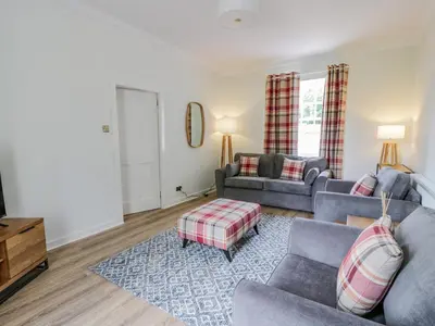 a living room with two couches and a table at North Firbank - Culzean Castle in Maybole
