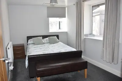 a bedroom with a bed and a window at Milo's place is a home from home in Egremont