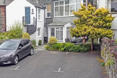 a car parked in a parking lot in front of a house at Keswick View in Keswick