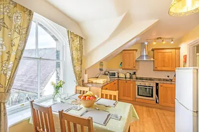 a kitchen with a table with a bowl of fruit on it at Keswick View in Keswick