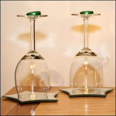 two wine glasses sitting on top of a wooden table at Cairnryan Bed and Breakfast in Cairnryan