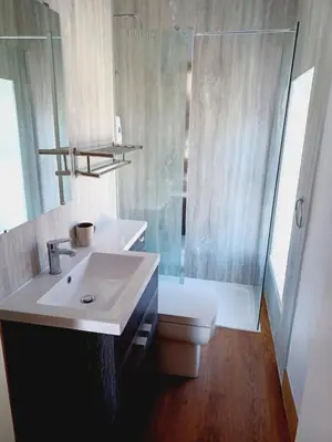 a bathroom with a sink and a toilet and a shower at Voyage Hostel - Rooms with Shared Kitchen in Douglas