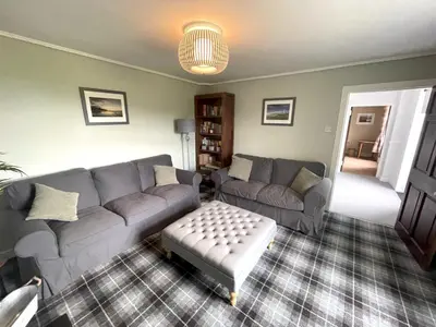 a living room with a couch and a table at Spacious 3BR Cottage in Beautiful Rural Setting - Pass the Keys in Castle Douglas