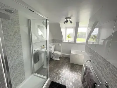 a bathroom with a shower and a toilet and a sink at Spacious 3BR Cottage in Beautiful Rural Setting - Pass the Keys in Castle Douglas