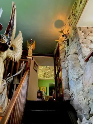 a staircase in a house with a stone wall at Buittle Castle Exclusive Use- Stay in your own Castle! in Castle Douglas