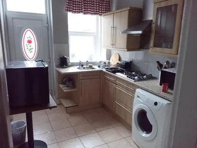 a kitchen with a sink and a washing machine at Lower Flat in Dumfries