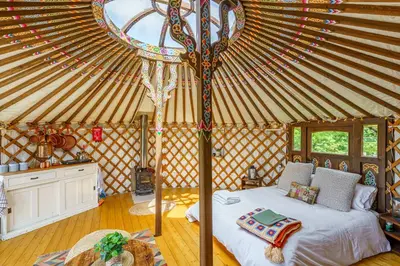 a bedroom with a bed in a yurt at The Kites Rest at Castle Creavie Farm in Kirkcudbright