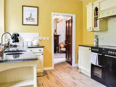 a kitchen with a sink and a stove top oven at Beautiful Traditional secluded country cottage in Sanquhar