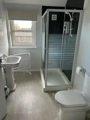 a bathroom with a shower and a toilet and a sink at Rooms at the Bush in Wigton