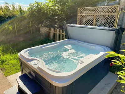 a jacuzzi tub sitting in a yard at Low Moat in Canonbie