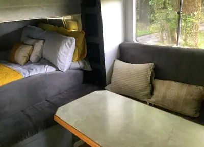 a living room with a couch and a table at Dobbin the horse box in The Lake District in Cockermouth
