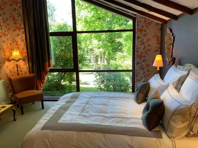 a bedroom with a large bed with a large window at Havenwood in Ayr